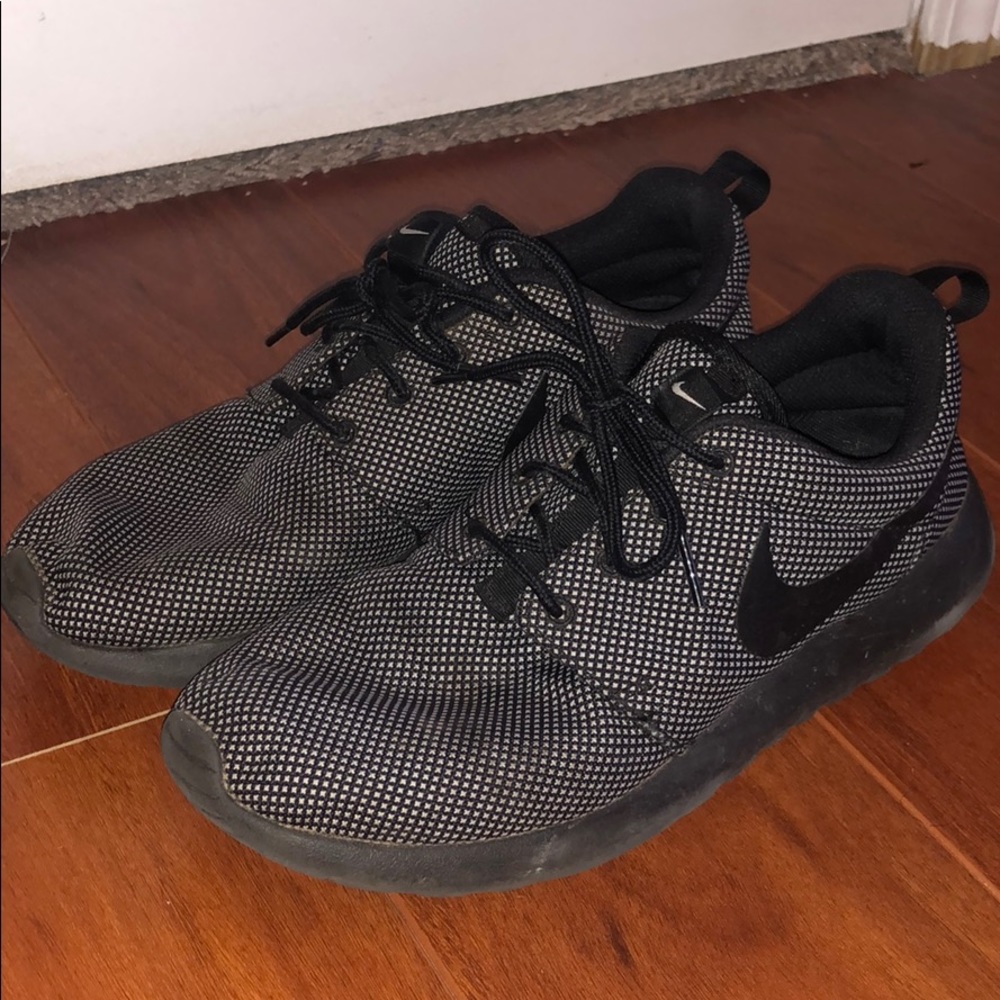 Black with white specks Nike Roshes.